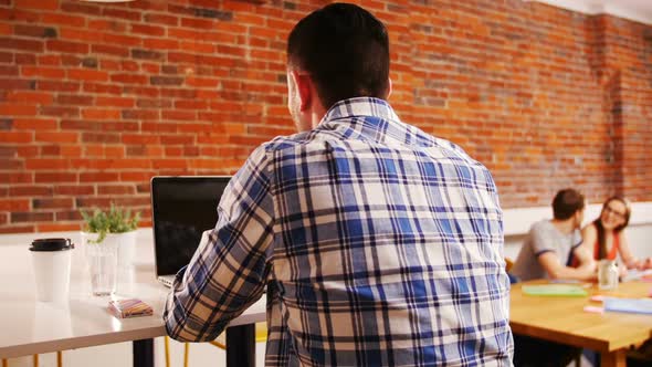 Executive using laptop in creative office 4k