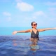 Young asian woman enjoy around outdoor swimming pool for leisure - VideoHive Item for Sale