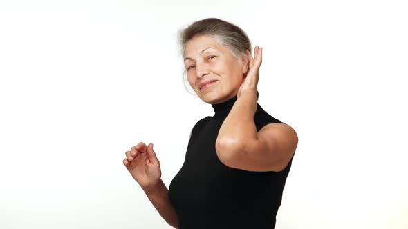 Slow Motion Portrait of Adult Pretty Woman with White Tied Hair Looking at Camera Smiling Touching