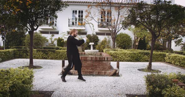 Man Performing Martial Arts In Garden