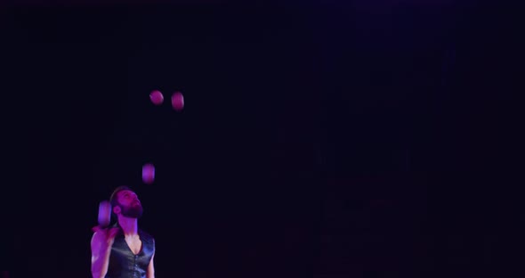 Juggling a Lot of White Balls on Stage Professional Circus Performer