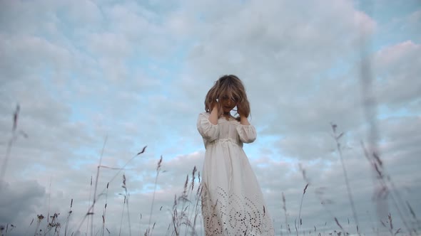 Graceful Female in Rural Field Under Blue Sky