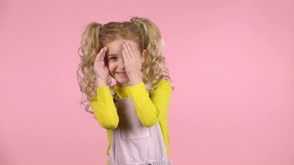 Beautiful Cute Female Child Is Hiding Face with Fingers. Slow Motion