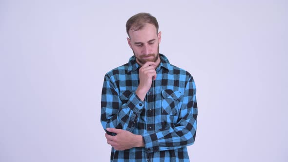 Serious Bearded Hipster Man Thinking and Looking Down