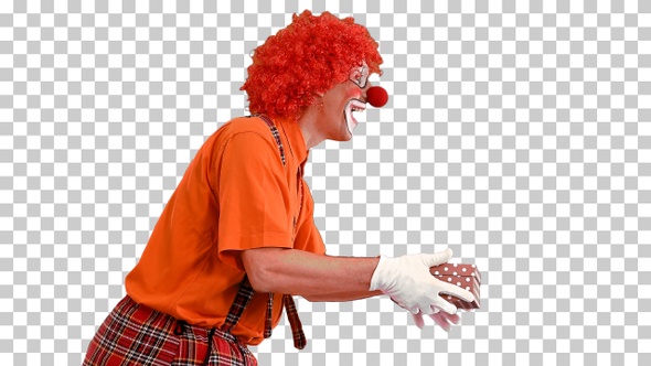 Male clown carrying a present, Alpha Channel