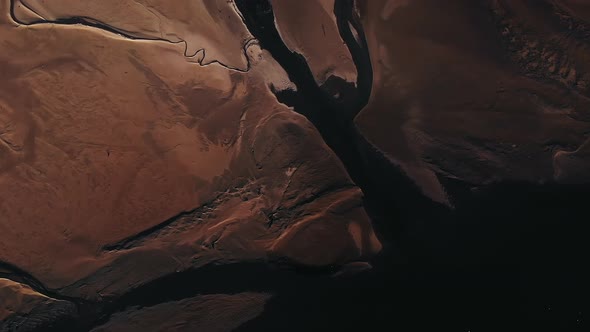 mars looking landscape of river streams revealing a small peninsula