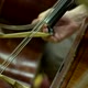 Cello bow playing the strings on an instrument - VideoHive Item for Sale
