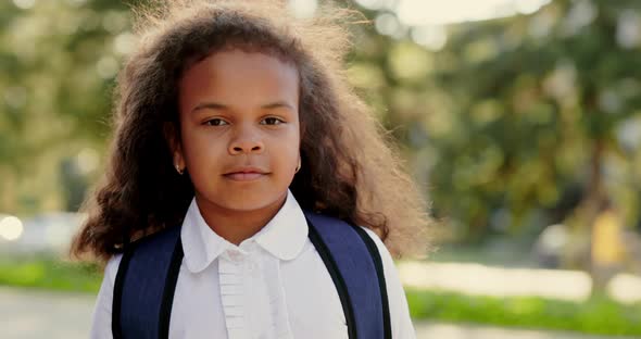 Girl in School Clothes Looking at the Camera