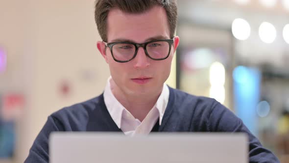 Close Up of Young Businessman Working on Laptop 