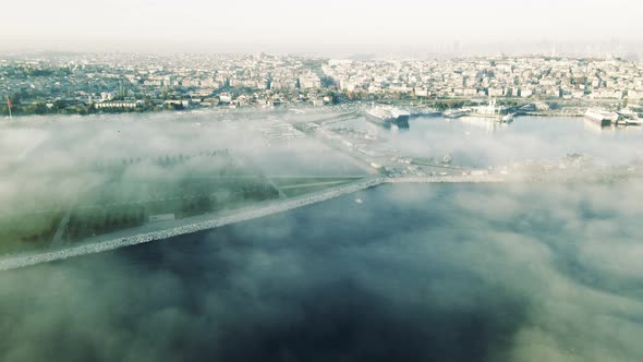 drone flying above sea with city view in foggy day