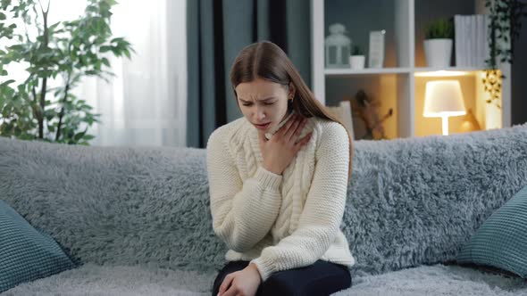 Young Brunette Coughing at Home