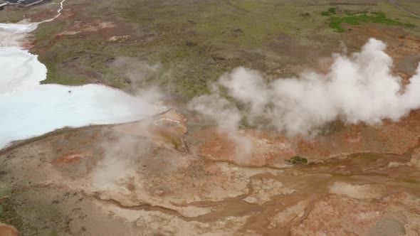 Landscape Of Sulfur Valley With Smoking Fumaroles, Geothermal Area In Iceland - aerial drone shot