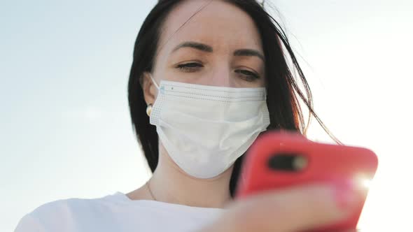 Beautiful Young Woman Wearing Protective Medical Face Mask Standing On The Street