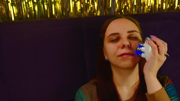 A Woman with Problematic Skin Using Face Electric Massager