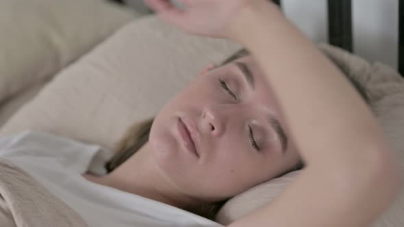 Beautiful Young Woman Sleeping in Bed at Home
