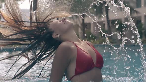 Happy Girl Throws Long Hair Back in Resort Pool Slow Motion