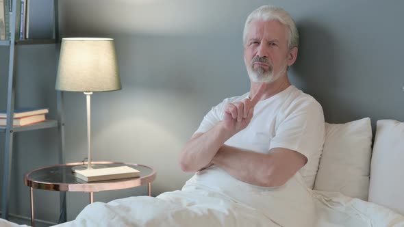 No Sign By Old Man Sitting in Bed, Disapprove 