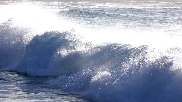 Waves Crashing on the Sandy Beach with an Udidentified People on Oahu, Hawaii