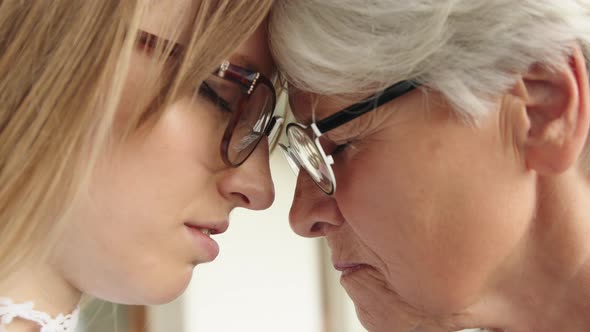 Close Up Shot of Young and Senior Woman Touching Foreheads