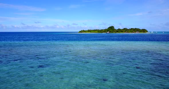 Beautiful fly over island view of a paradise sunny white sand beach and aqua turquoise water backgro