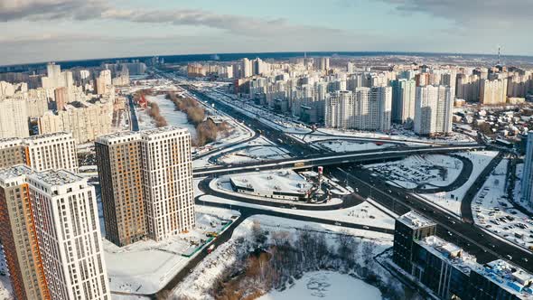 Drone Flying Above Winter Town Residential District Covered with Snow and Road Junction with Moving