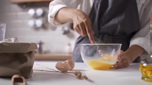 Chef In Apron Whisking Egg Yolks While In The Kitchen, Vegetable Food Cooking, Vegetarian Eggs