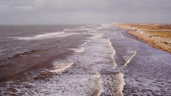 Aerial View Of Rough Sea Waves Along Katwijk aan Zee Beach Coastline In South Holland. Dolly Back Ti