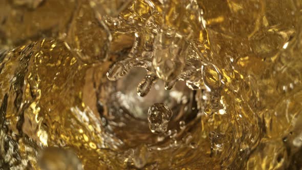 Super Slow Motion Shot of White Wine Whirling in Glass Bottle at 1000Fps