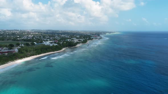 Drone captures soft sea waves and white beach in Bridgetown, Barbados