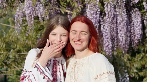 Girlfriends in National Traditional Clothes Vyshyvanka Hug and Smile in Nature