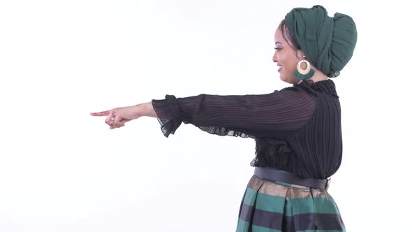 Profile View of Happy Young African Muslim Woman Pointing Finger