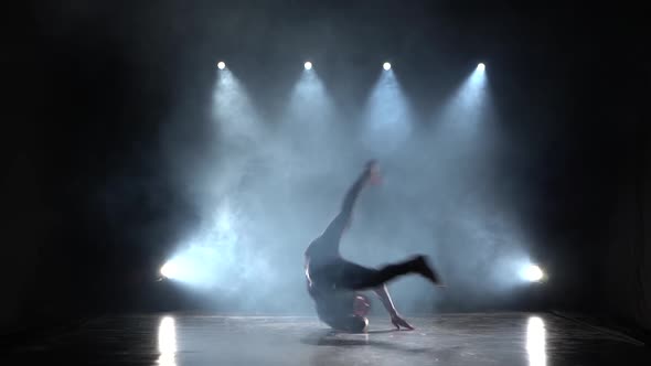 Silhouette of a Talented Young Break Dancer. Hip Hop Street Dance on a Stage in Front of the