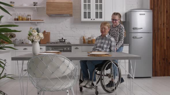 Handicapped Woman Having Breakfast in Home Kitchen