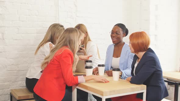 Team Work Process. Multiracial Group of Women Coloborating in Open Space Office.