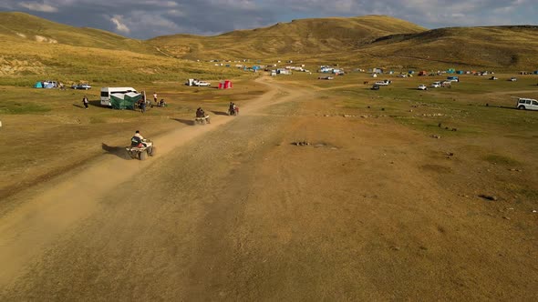 Aerial View From Behind ATVs by Lake and Mountain