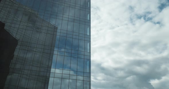 Timelapse of Sailing Clouds Reflecting in Glassy Skyscraper