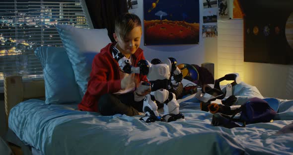 Boy Playing with a Toy Robot