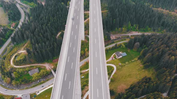 Aerial Top View of Highway Viaduct with Multilane Traffic in Mountains. Autobahn in Austria
