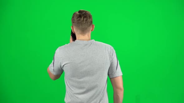 Guy Goes and Talks on the Phone, Chroma Key. Back View. Slow Motion