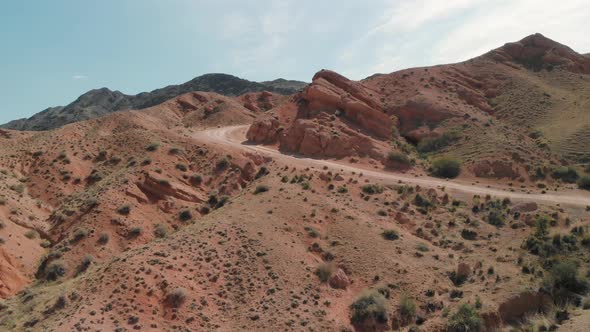 Drone Shot of Bicyclist Ride in the Desert Canyon