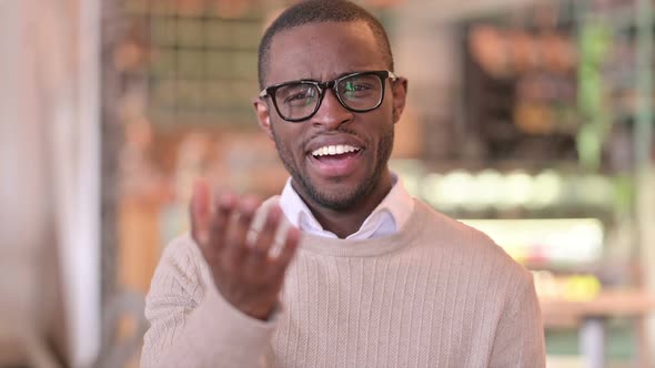 Portrait of Assertive African Man with Pointing and Inviting