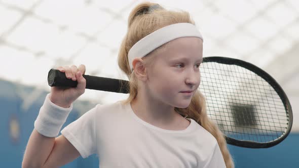 Smiling Little Girl On Tennis Court