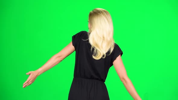 Blonde Female Is Walking. Chroma Key. Slow Motion. Back View.