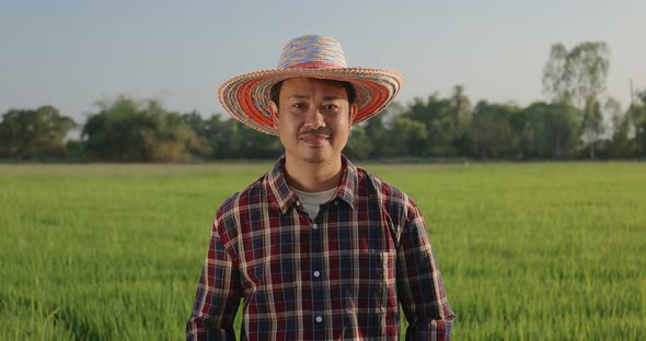 Zoom out Portrait Happy Asian Farmer arms crossed smiling and looking at camera.