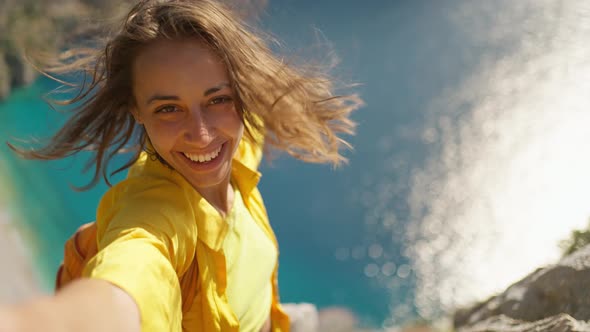 Positive Tourist Woman Taking Picture Outdoors for Memories Making Selfie on Top of Cliff with