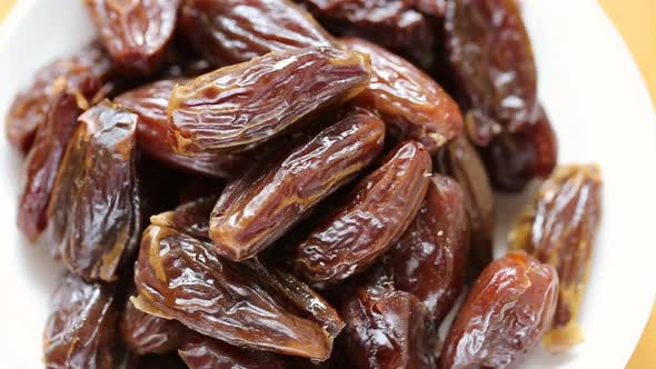 Dry dates close-up in a white plate