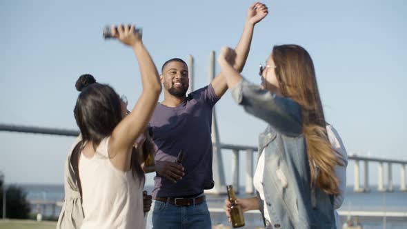 Happy Company Jumping with Raised Hands