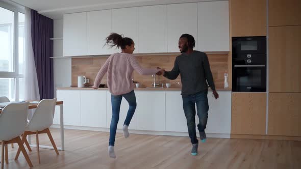 Active Happy African American Family Jumping Dancing and Having Fun at Home