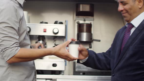 Arab Businessman Getting Coffee to Go from Mobile Van