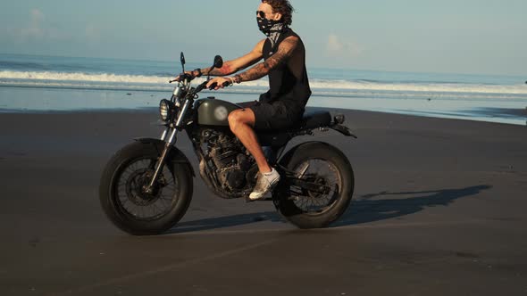 Lonely Biker Ride Along the Ocean Beach